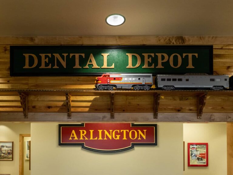 A model train runs on a track high on the wall of the Arlington dental clinic.