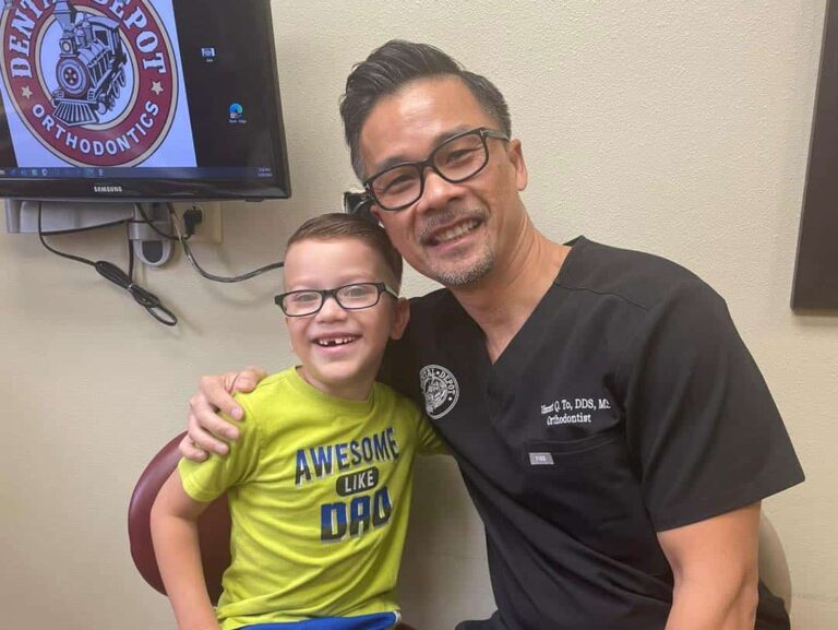 Dr. To hugs a young orthodontic patient.