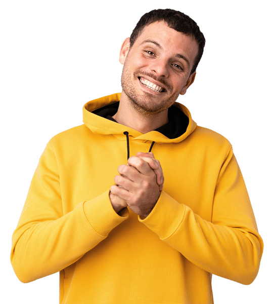 A young man in a yellow hoodie has a big smile