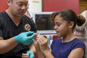 A girl is shown an Invisiline model while at dental depot