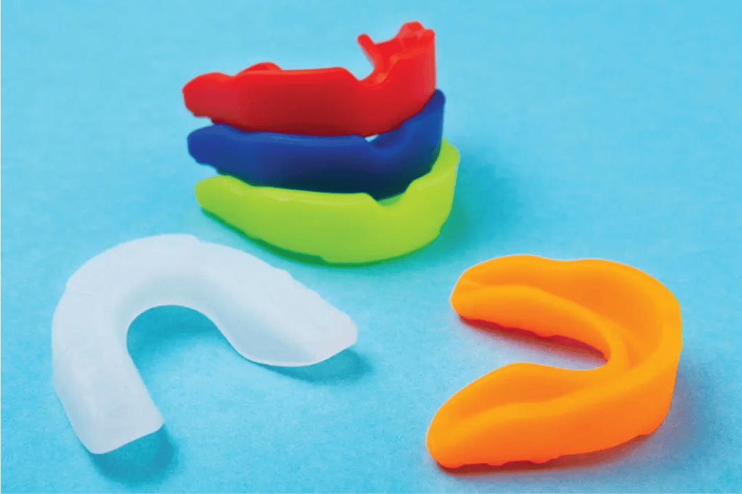 colorful mouthguards with a light blue background