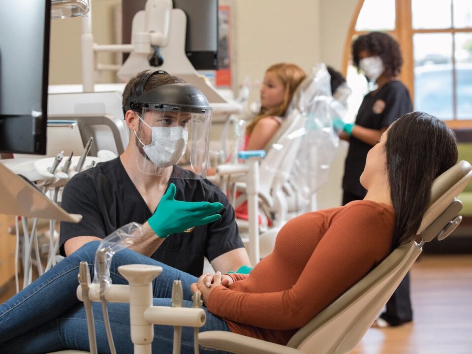 Female patient receiving emergency treatment from dental depot dentist