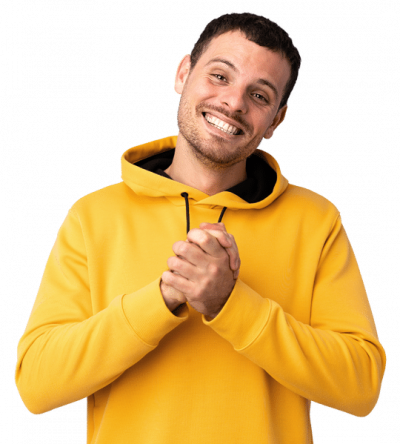 A young man in a yellow hoodie has a big smile