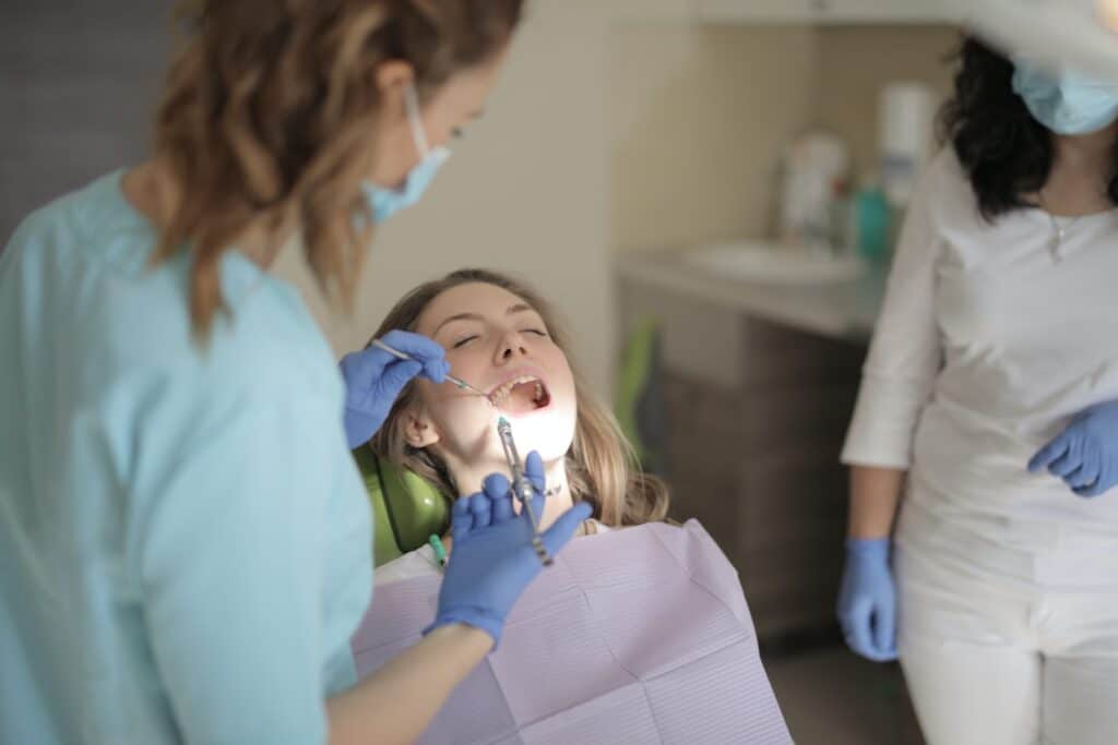 A woman is getting a botox injection at the dentist